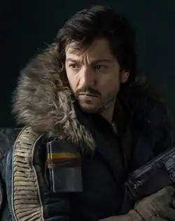 Cassian wielding a blaster in Rogue One (2016).