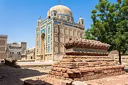 An unmarked grave outside a mausoleum