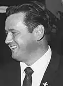 A black-and-white photograph of Don Wright in profile smiling