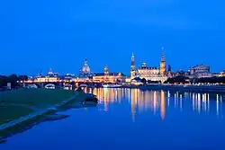 Several Baroque buildings in Dresden old town, reflected in the River Elbe