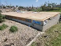 A bare structural foundation with the words "OFF METER" spray-painted on the side