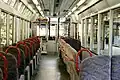 Semi-cross seating with long seats on one side facing windows, Eizan Electric Railway 900 series Kirara.