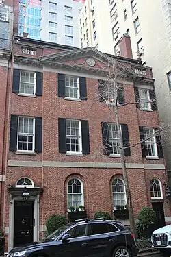 A brick house with a peaked roof