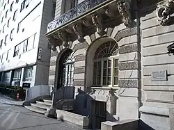 The ground floor, with the main entrance on the left and an arched window on the right