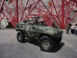 A VBL with a multi-scale camouflage and an FN MAG machine gun during an exhibition