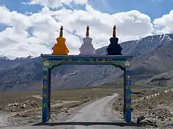 Entrance arch to spur road to Kumik village