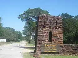 A road passing through a stone entrance in the grasslands