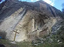An small Hermitage located under a huge overhanging cliff
