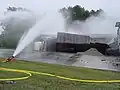 Fire Department using a ground monitor to suppress vapors