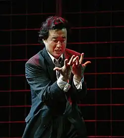 man looking at his hands with an expression of despair