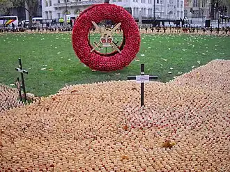 Massed tokens of remembrance and a large wreath at the Field of Remembrance
