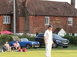 Fielder in front of Bat and Ball public house