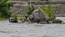 A mud house in Mongla of Bagerhat district, Bangladesh, nearly inundated by rising water levels.