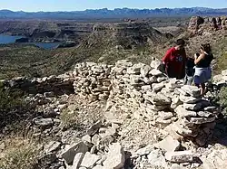 Hikers inspecting ruins.