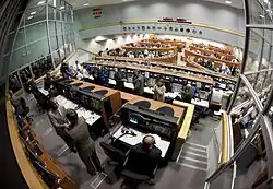 Bolden, left, congratulates Leinbach and the launch team in Firing Room Four of the Launch Control Center for a successful launch.