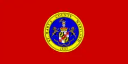A red flag with the county seal in the center