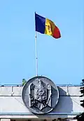The flag and Moldovan coat of arms on the building