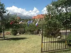 A circle of flags at the entrance to Garden of the Gods in Colorado, Springs, Colorado. The flags of Russia, Greece, and the Republic of China are visible in the foreground, just downhill from the gates to the parking lot.