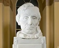 A white marble bust of Abraham Lincoln's head, looking forward.
