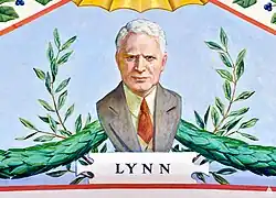 A painting depicting a portrait of David Lynn. He is wearing a grey suit with a red tie, and is looking directly forward. Behind him are green garlands and plants, and directly under him is the text "LYNN".