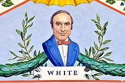 A painting depicting a portrait of George M. White. He is wearing a blue suit with a red tie, and is looking directly forward. Behind him are green garlands and plants, and directly under him is the text "WHITE".
