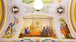 The mural depicts (from left to right) Benjamin Franklin, Roger Sherman, Thomas Jefferson, Robert Livingston, and John Adams. On the wall in the background is a portrait of English philosopher John Locke.
