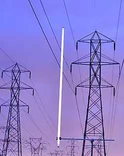 Capacitive coupling from high-voltage power lines can light a lamp continuously at low intensity.