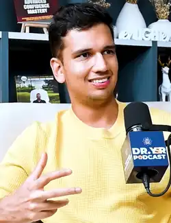 Portrait photo of Himatsingka smiling in a yellow shirt