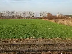Place of the former Nazi German concentration camp with barracks for prisoners built in 1944 in the background on the left