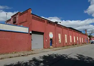 A red-painted brick industrial building