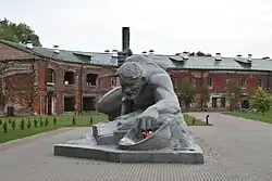 Monument to a soldier with a brick fortress in the background