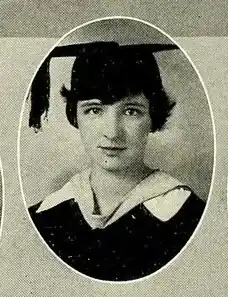A young white woman wearing an academic cap and gown
