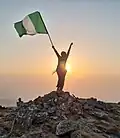 Person on the summit of a Nigerian mountain at sunset