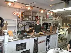 Inside Coyotes Oaties location which once housed the Historic Filers Bakery (founded in 1939); posing is co-owner Annette