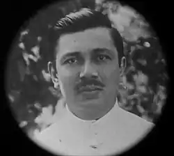 A man in a white shirt looking forward