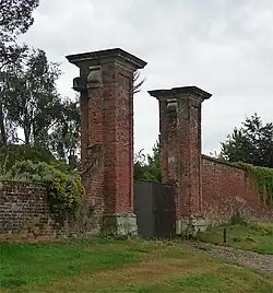Pair of gate piers and approximately 2 metres of wall to east and west of piers on edge of Park Lane 162 metres west of entrance to churchyard