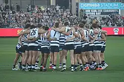 Team huddle on surface of playing arena