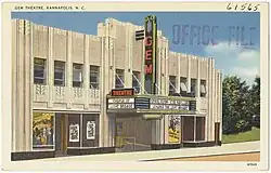 A postcard of a theater with a large sign that says “Gem” written vertically in large neon red lettering.