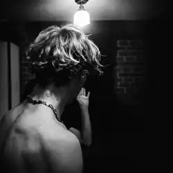 Ross Lynch shirtless and looking away from the camera in black and white.