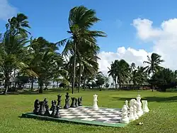 A giant outdoor chessboard, with pieces about three feet (91 cm) tall