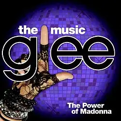 The word "Glee" is written in large lowercase black letters with white outline. Instead of the letter "l", a hand covered in lace fabric and wearing bracelets has its index finger and thumb in the form of the capital letter.