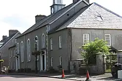 A side view of a church building with a dark facade