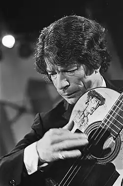 black-and-white image of Manitas de Plata playing acoustic guitar