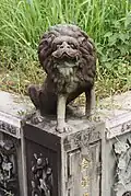 A Chinese stone lion statue on a grave