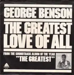 Text in uppercase and large size; black background. Artist name ("George Benson"), song title ("The Greatest Love of All"), and info about parent soundtrack album ("From the soundtrack album of the year, 'The Greatest' ") divided by lines. The song title is divided into two lines, breaking "Greatest" and "Love" apart. The soundtrack info contains the Arista Records logo on the leftmost and the cover art of the parent album on the right.