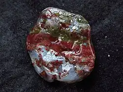 Green-and-red jasper pebble with areas of grey, translucent chalcedony, Aomori Prefecture, Shichiri Nagahama, Japan