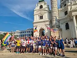 30-40 people posing in front of cathedral