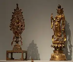 Two Guanyin statues in gilt-bronze; only small bronze statues like this have survived.