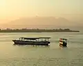 View from Gili Trawangan; in the foreground are island hopper boats anchored off Gili Trawangan, Gili Meno is the next island&nbsp;— Ginung Rinjani is in the distance