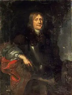 Oil painting of a middle-aged white man with long hair and a thin moustache, dressed in a cuirass with an undergarment with large, puffy sleeves. His body is turned slightly to the right, his face with a slight smile turned towards the viewer.